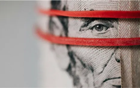 Dollar bills held together with rubber bands