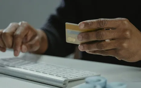 Person entering credit card details on a computer